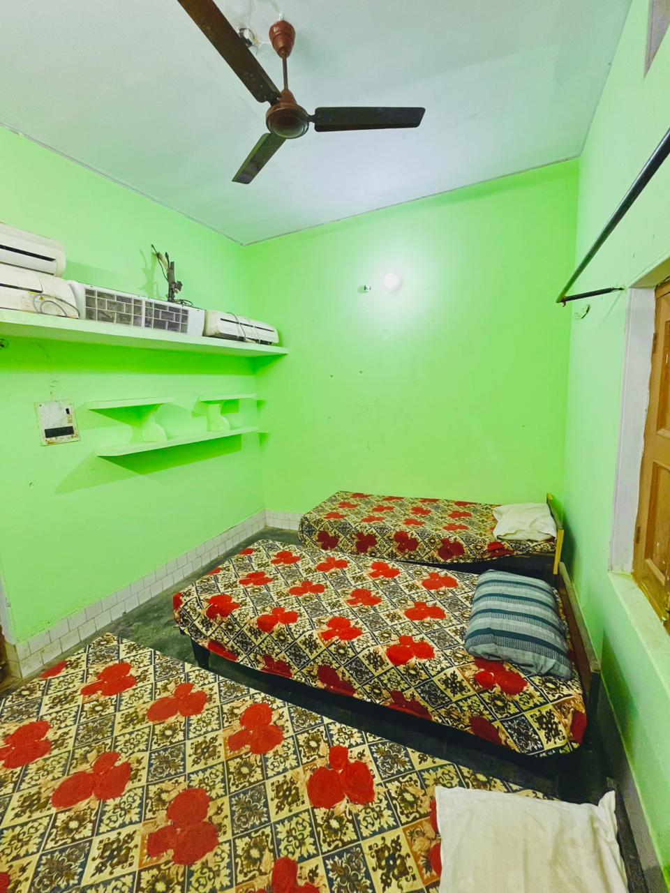 Private room with clean bedding, window and ceiling fan